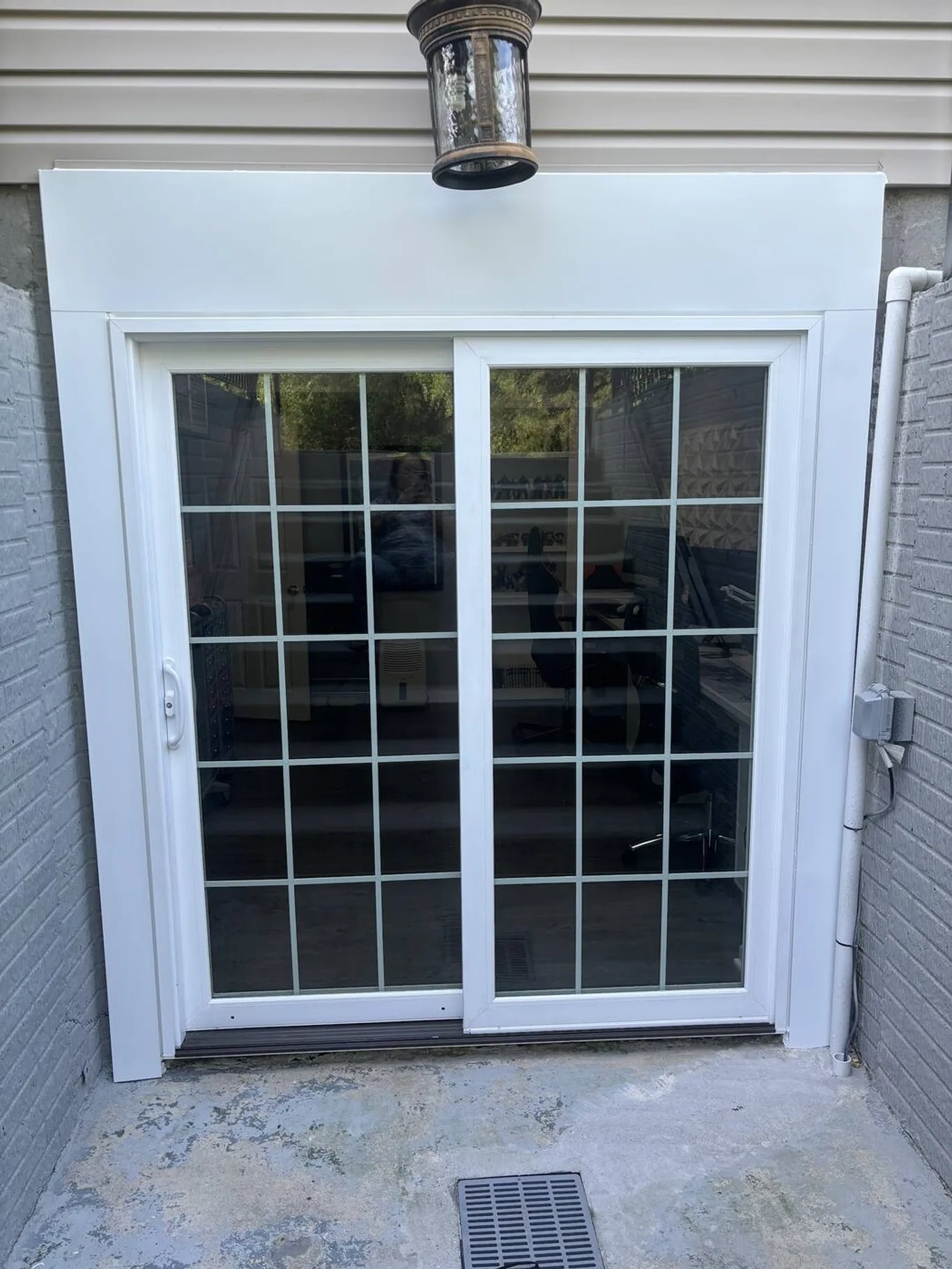 A sliding door with grilles set into a lower-level wall