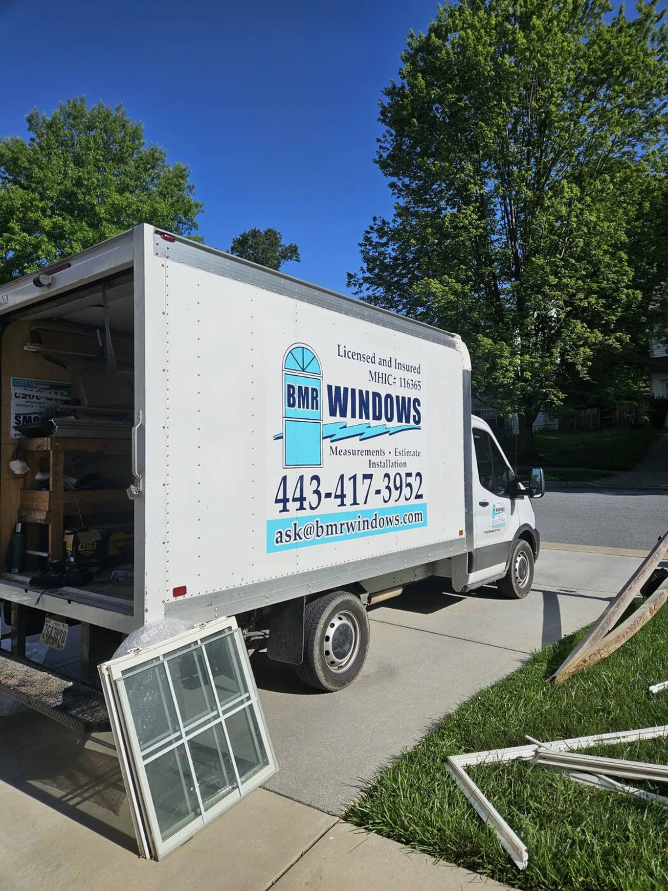 BMR's box truck in a driveway, an old window sash leaning on its bumper