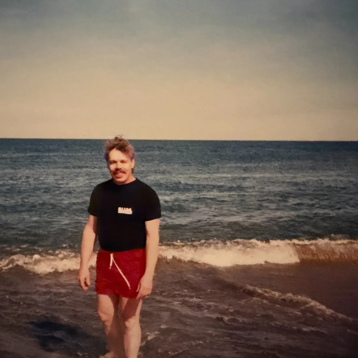 Tony standing by the water at the beach